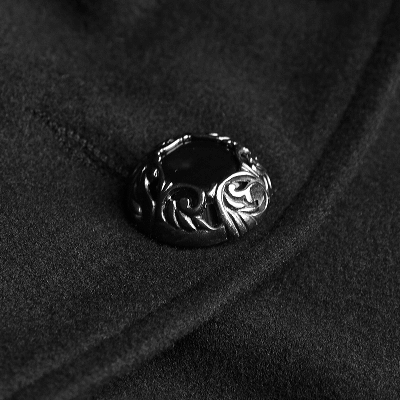 Close-up of an elegant black coat button with intricate gothic design, showcasing luxurious detail and style.