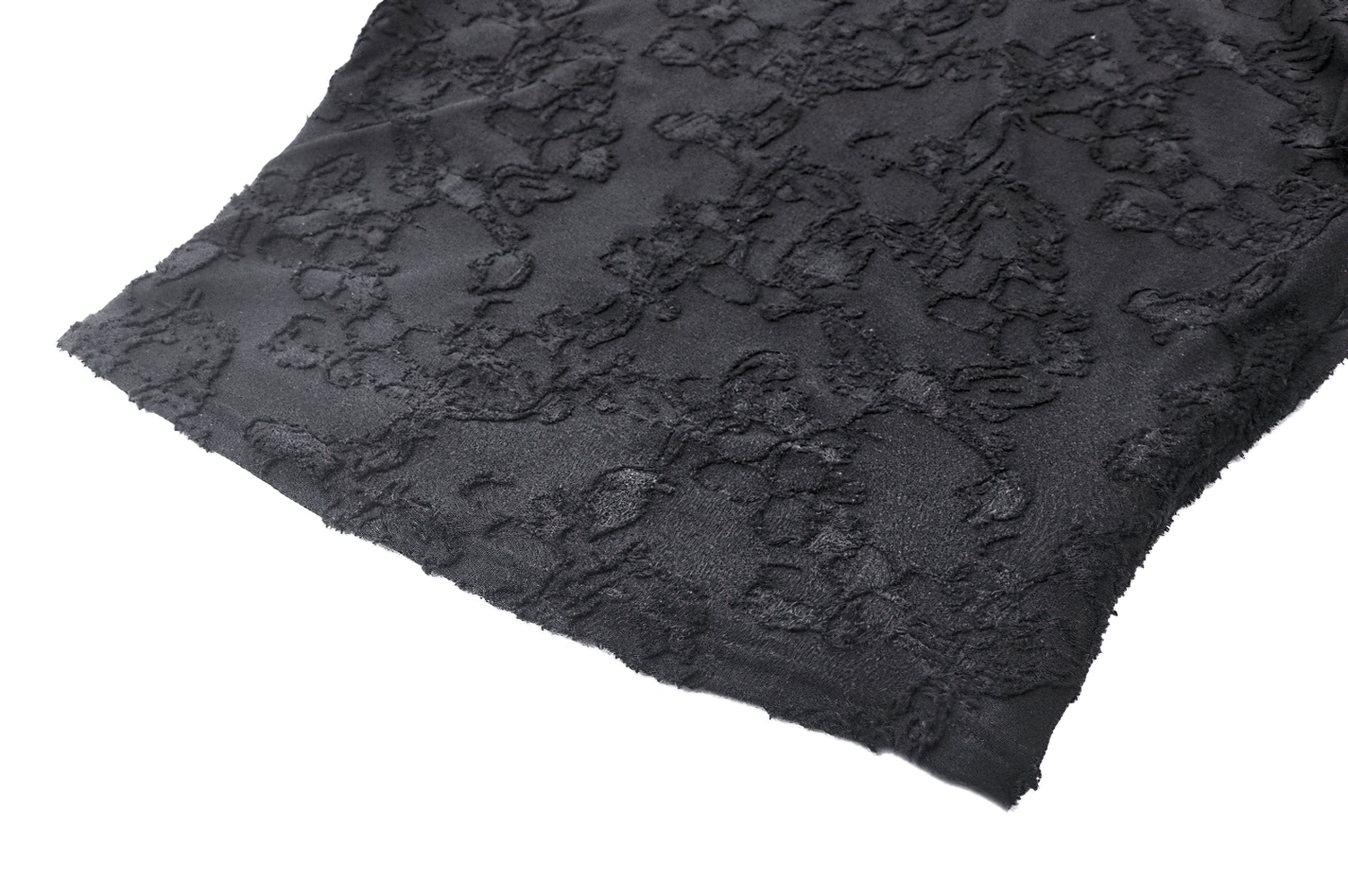 Close-up of elegant black lace fabric showcasing intricate detailing and texture for gothic fashion.