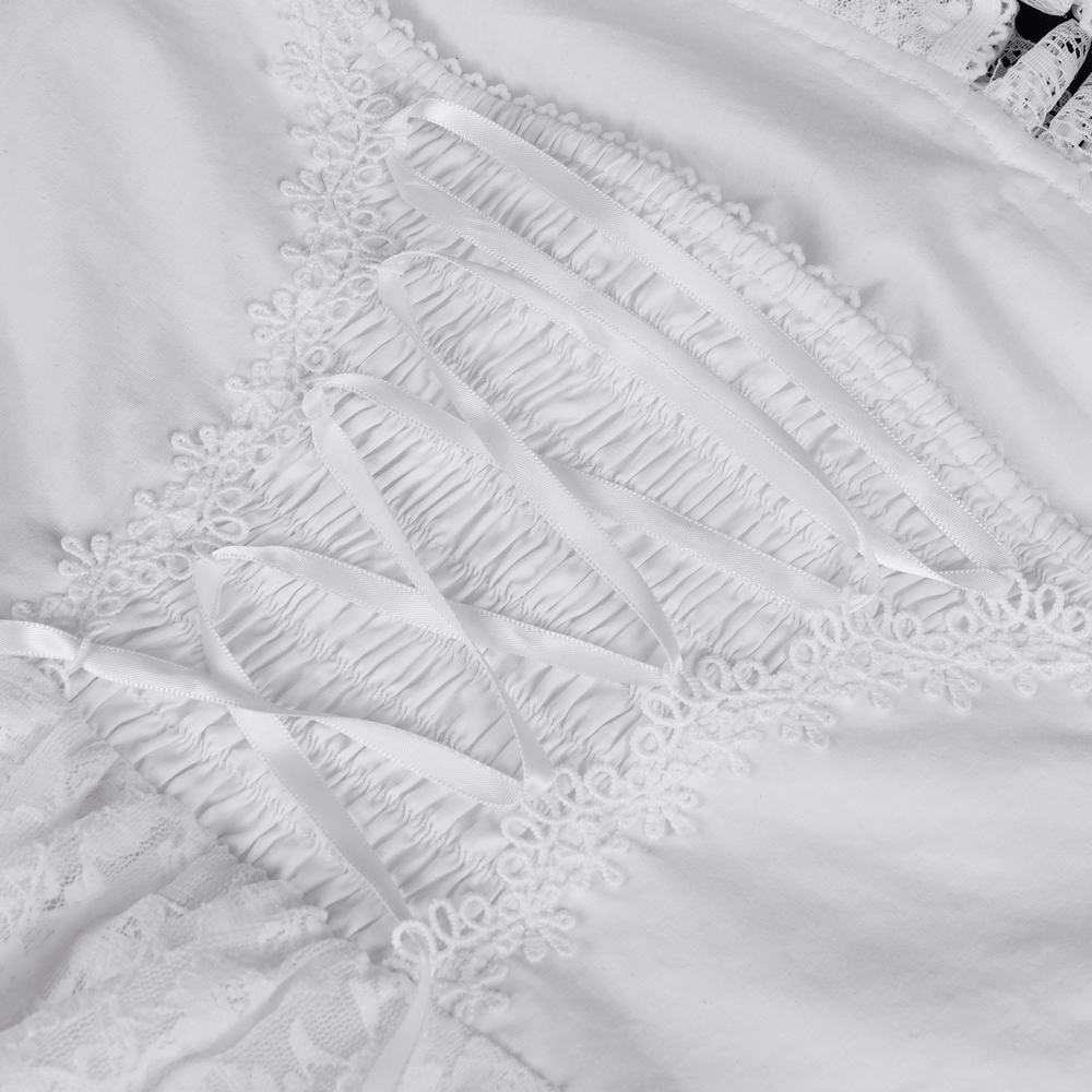 Close-up of elegant white halter dress detailing featuring ruffled trim and decorative lace for a sophisticated look.