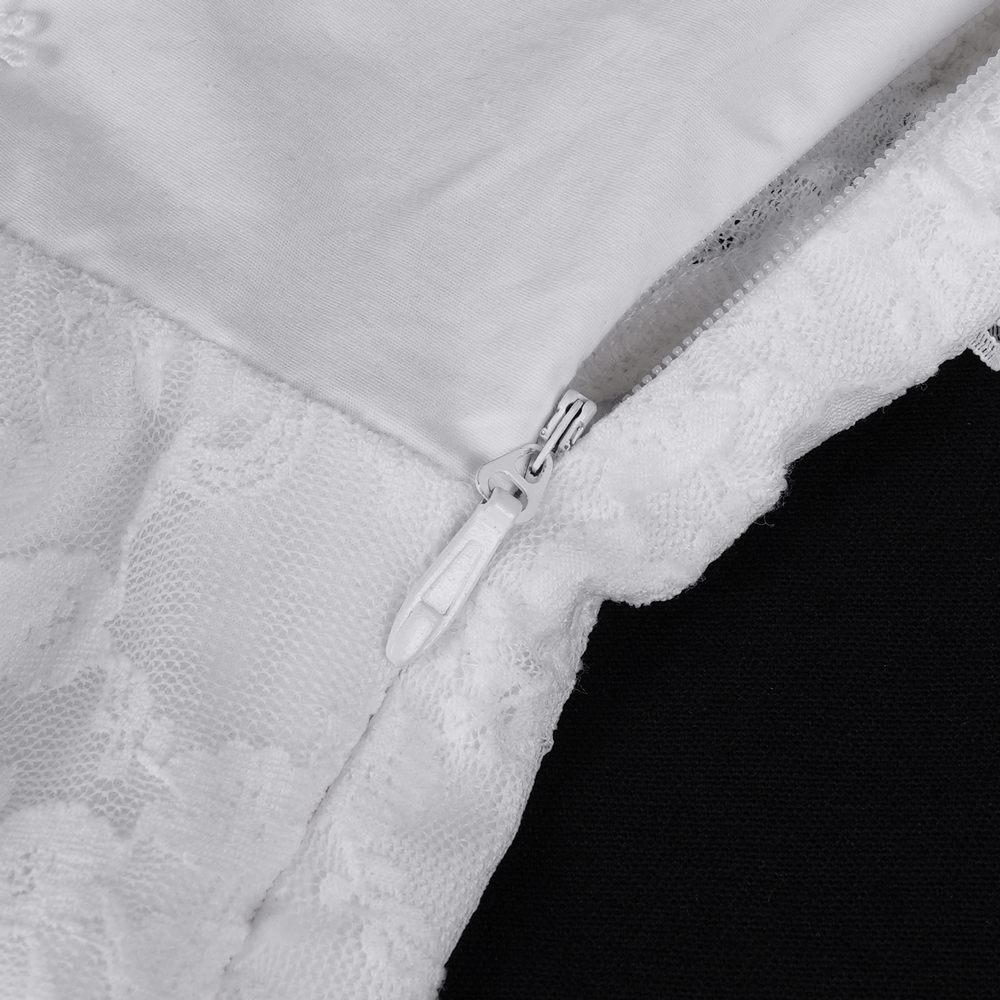 Close-up of the zipper detail on a stylish women's white halter dress with ruffle accents.