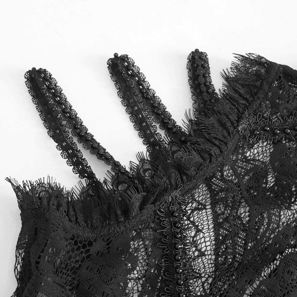 Close-up of elegant black lace fringe top showcasing intricate detailing and delicate straps.