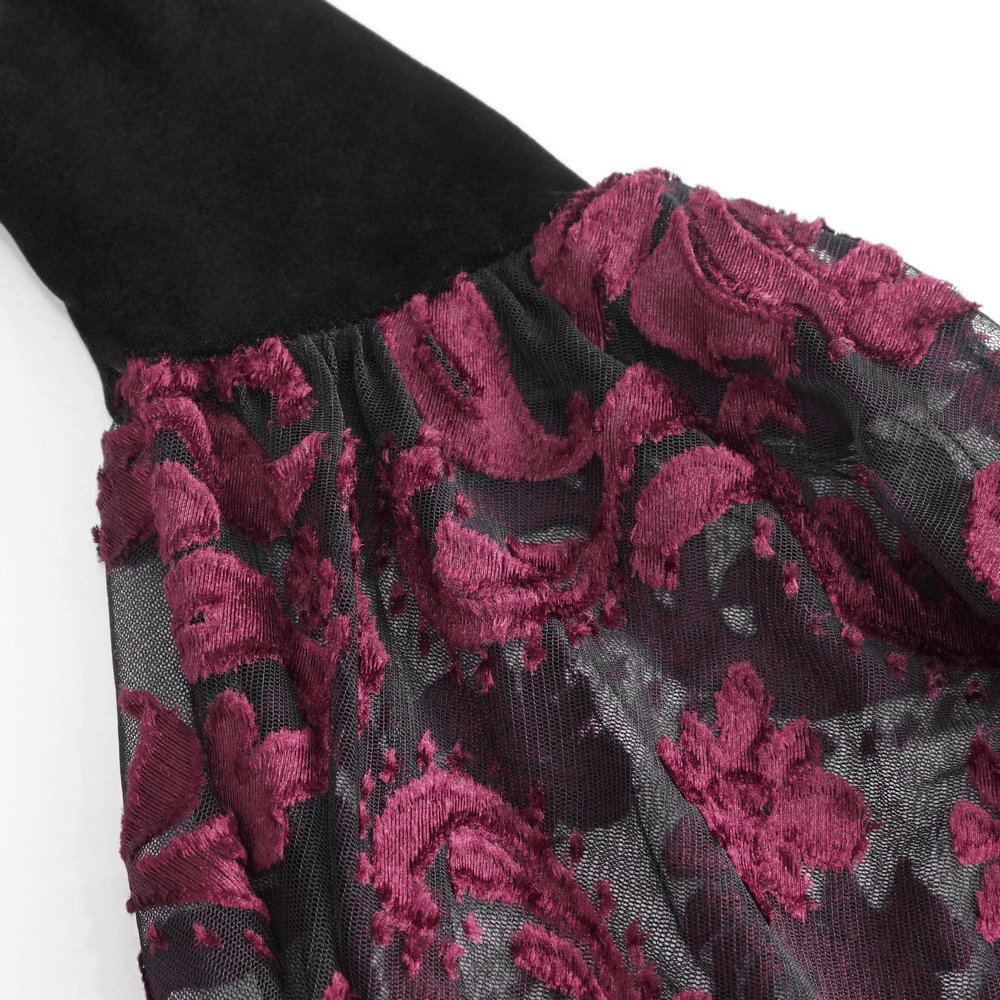 Close-up of elegant goth velvet top featuring rich burgundy lace sleeves and a sleek black velvet bodice.