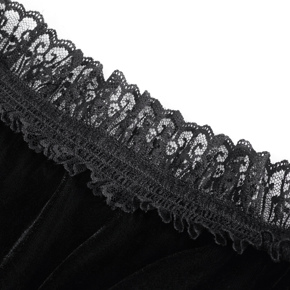 Close-up of elegant black velvet top with intricate lace neckline detail for a gothic look.