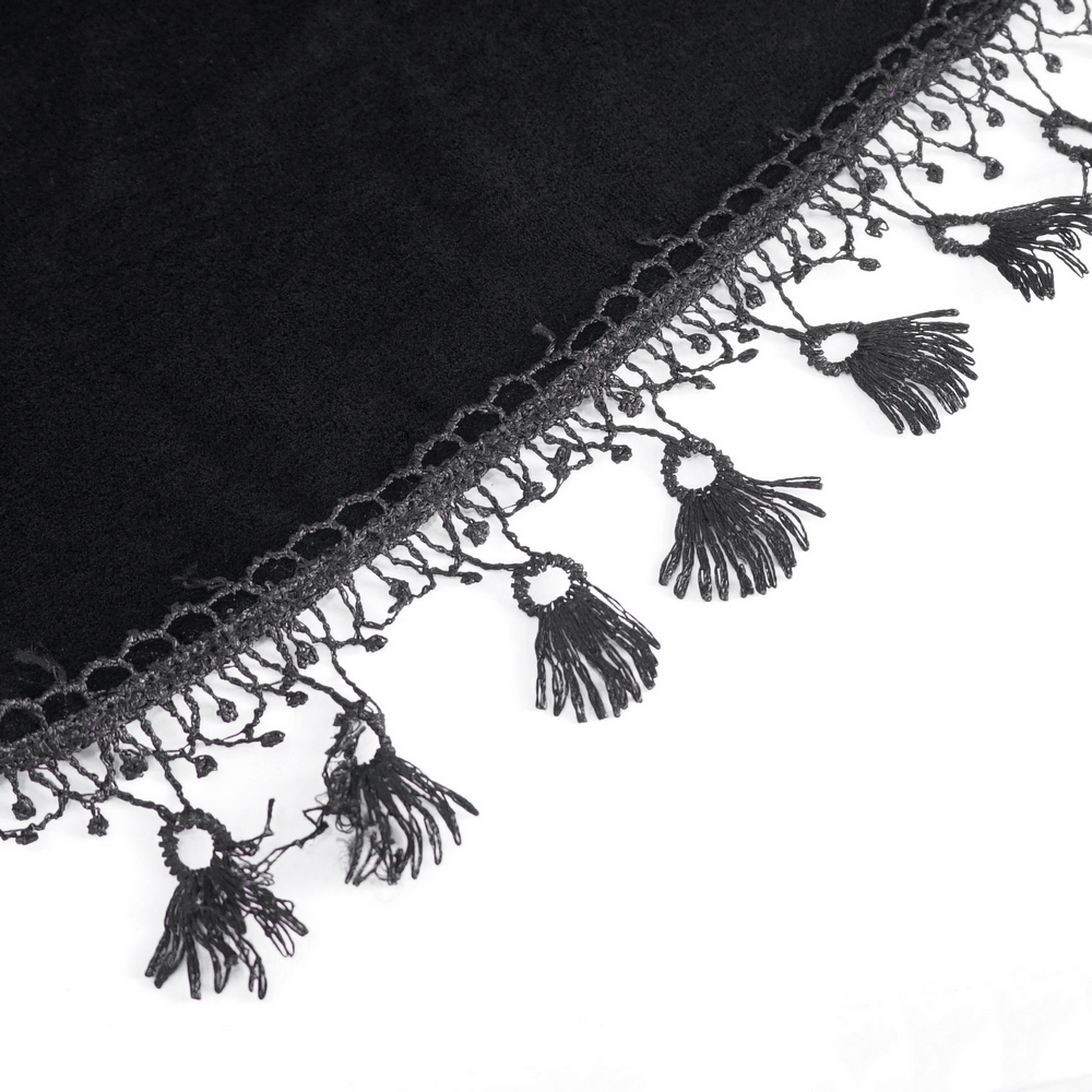 Close-up of black velvet fabric with intricate lace trim highlighting gothic design elegance.