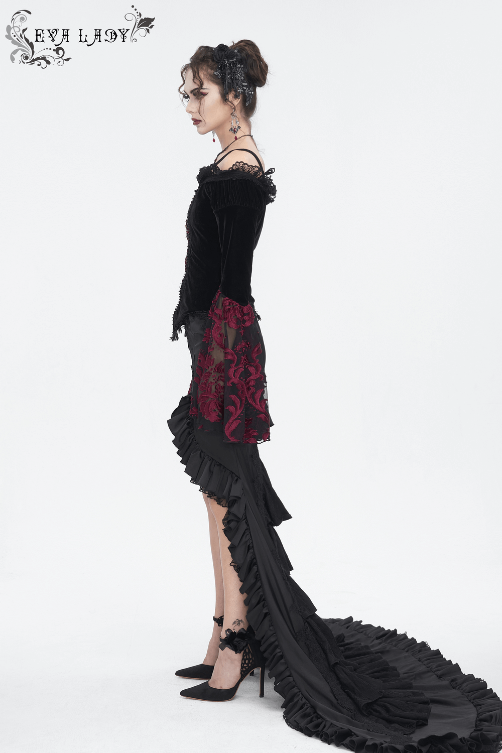 Elegant goth dress featuring black velvet and dramatic ruffled hem, perfect for a striking evening look.