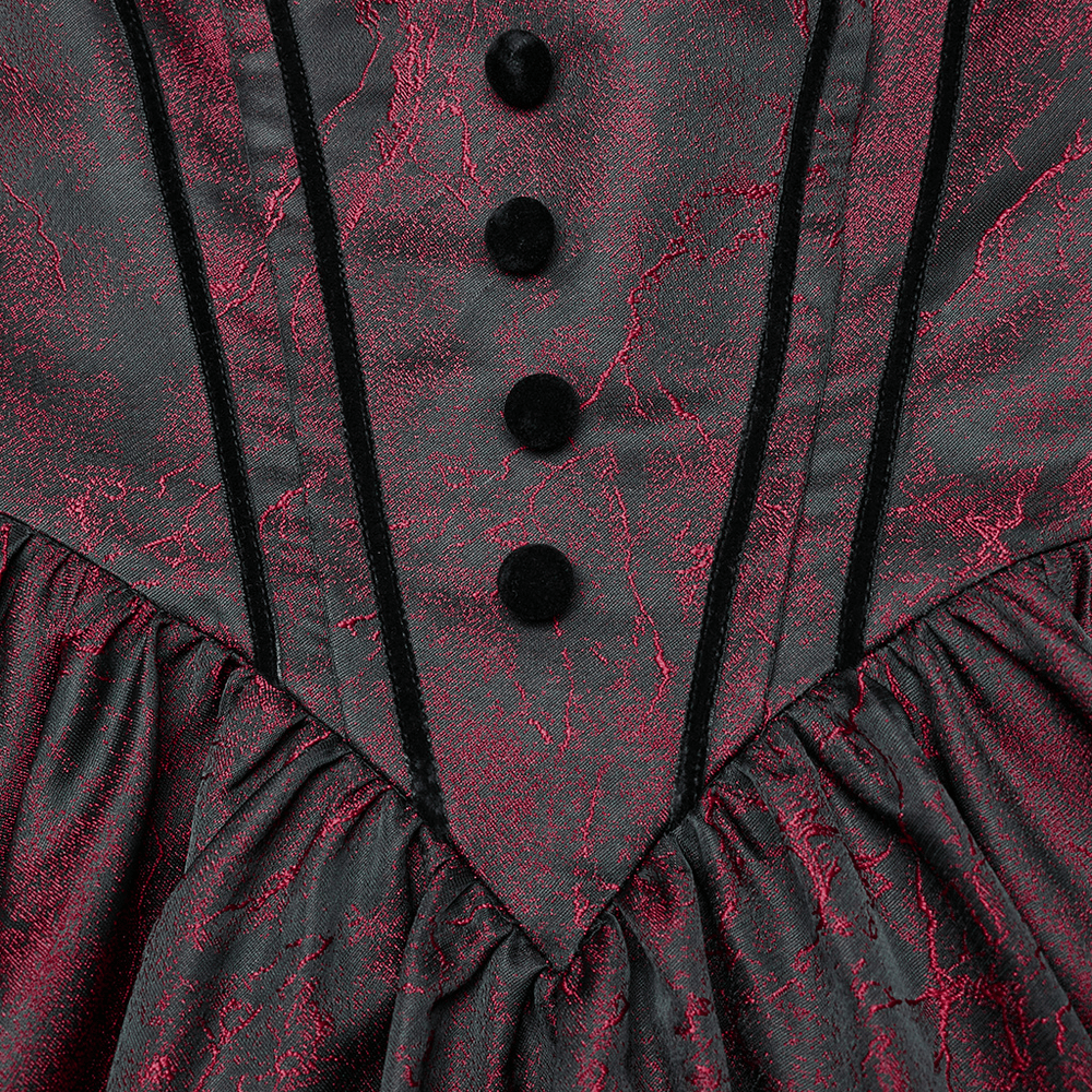 Close-up of elegant gothic ball gown detailing with velvet buttons and textured jacquard fabric in dark red and black.