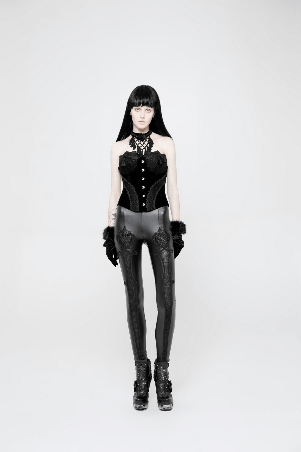 Model showcasing elegant gothic black lace faux leather leggings paired with a stylish corset and edgy accessories.