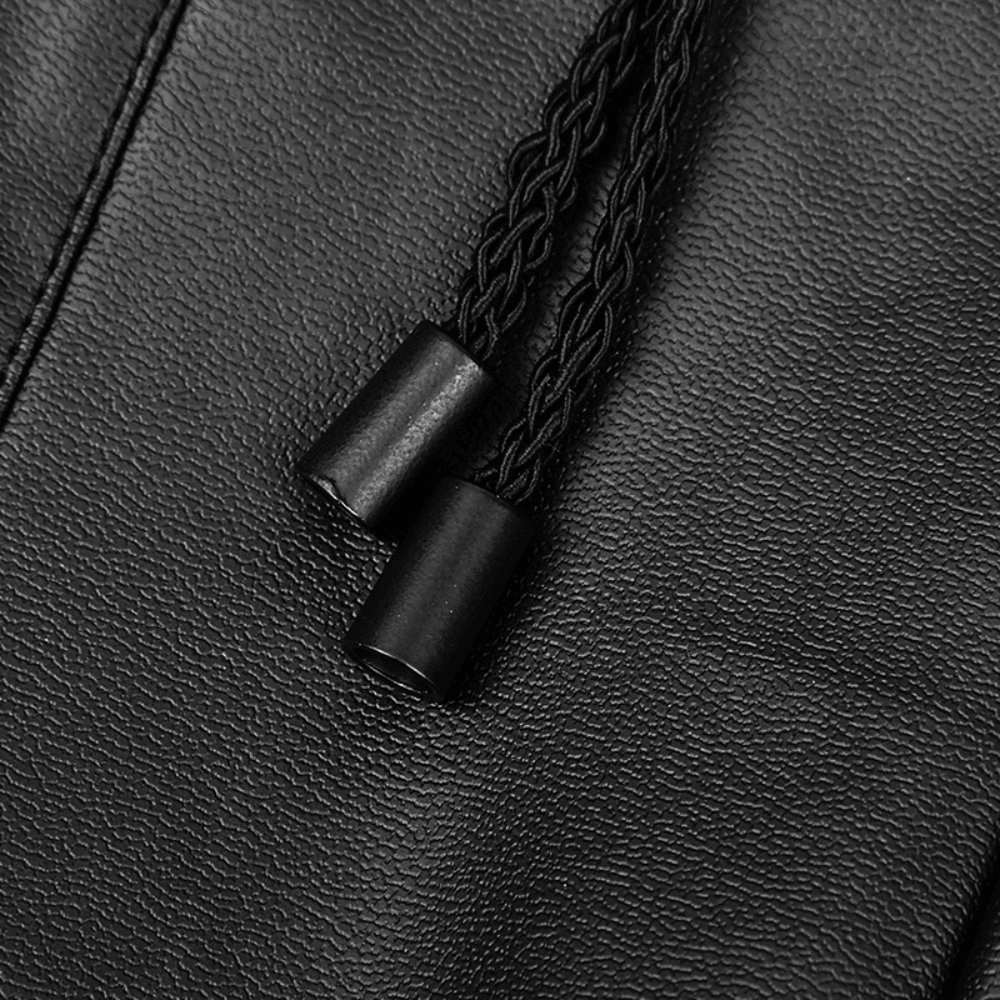Close-up of black faux leather leggings with stylish braided drawstrings for adjustable fit.