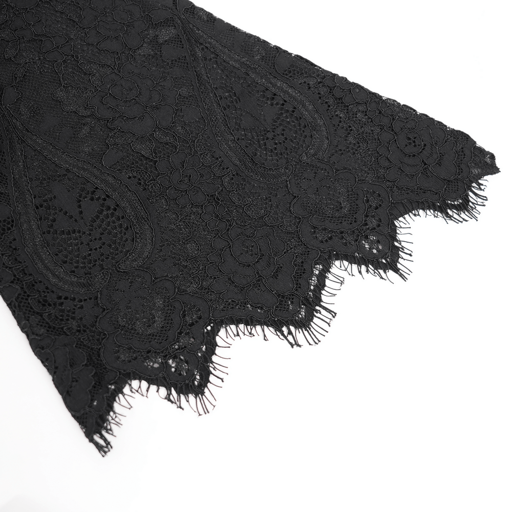 Close-up view of elegant black lace with floral patterns and frayed edges, perfect for gothic style outfits.
