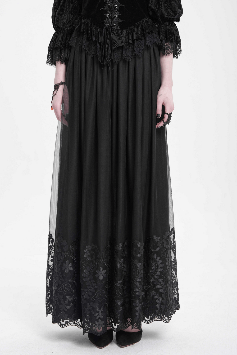 Elegant black mesh maxi skirt with embroidered hem, perfect for gothic and alternative fashion styles.