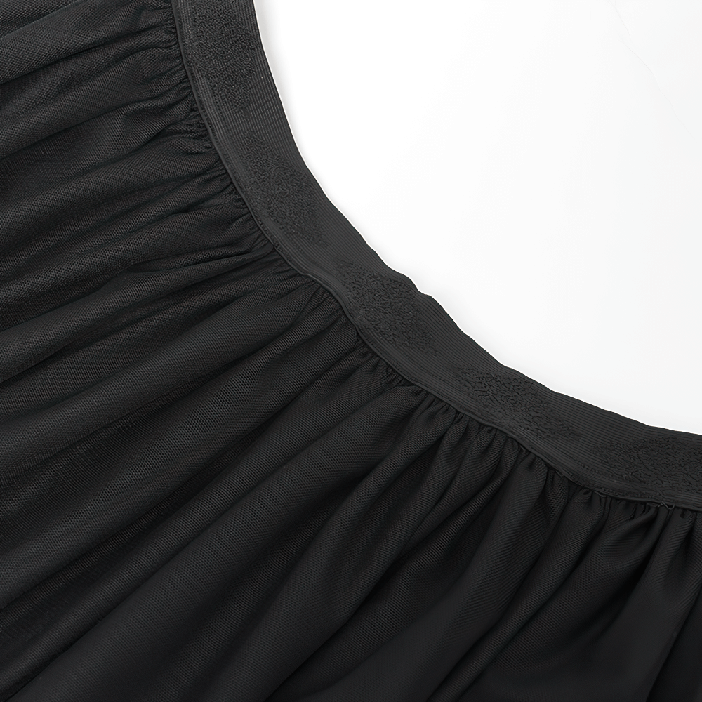 Close-up of the elastic waist and pleats of the elegant black mesh maxi skirt, showcasing intricate fabric texture.