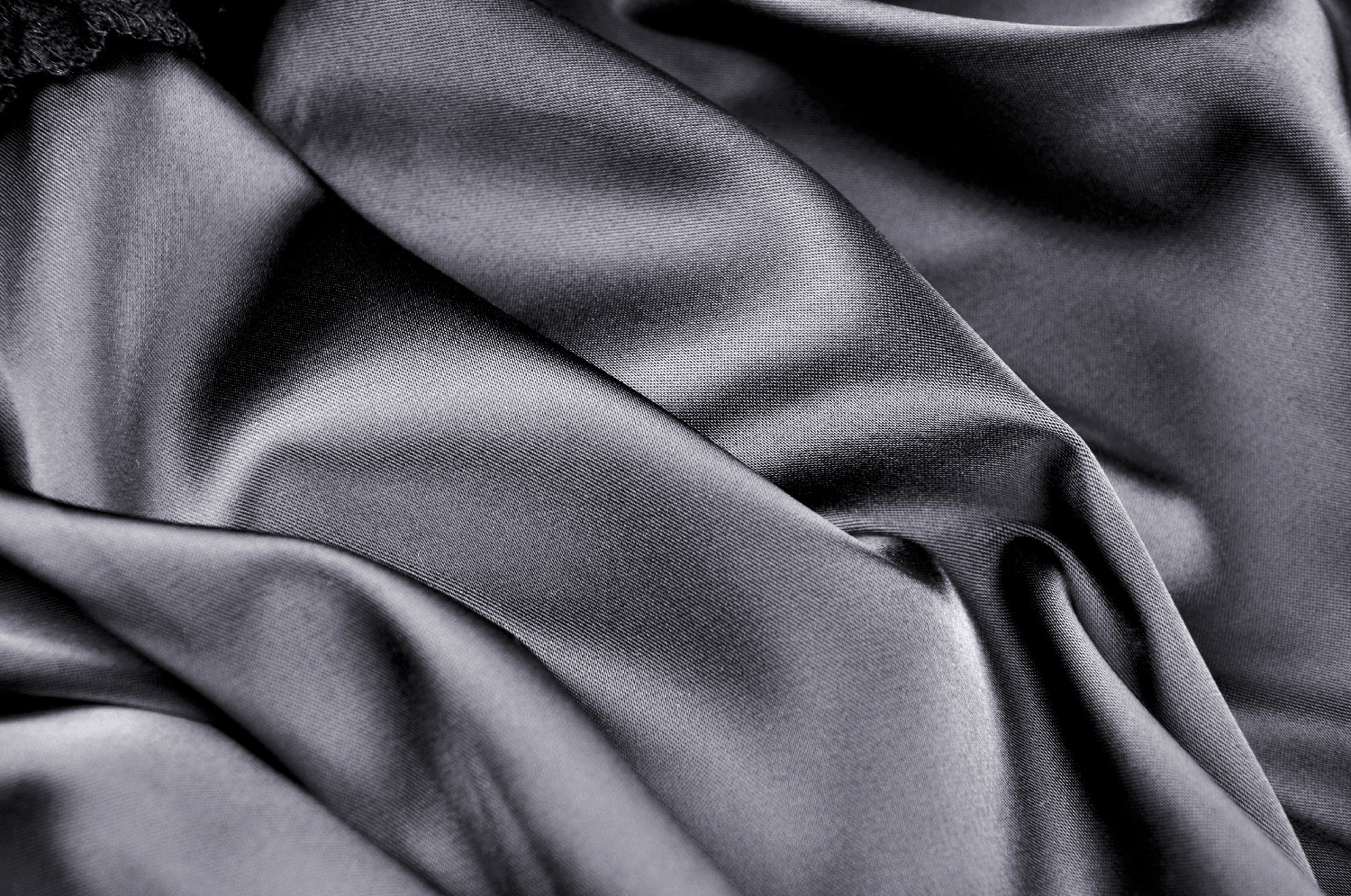 Close-up of luxurious black velvet fabric, ideal for an elegant gothic skirt. Soft texture with a rich sheen.