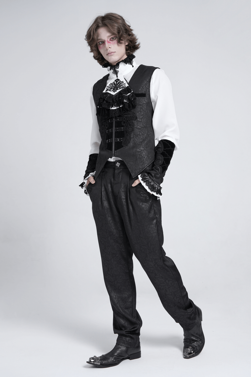 Elegant gothic outfit featuring a male model in a black vest and lace cuffs, exuding vintage aristocratic style.