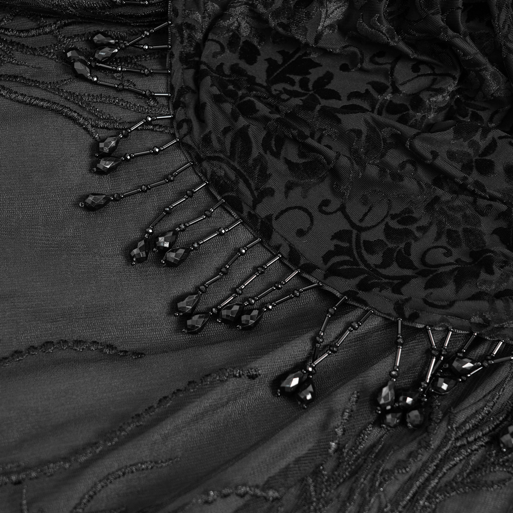 Close-up of elegant black velvet lace skirt with beaded drapes and floral embroidery details.