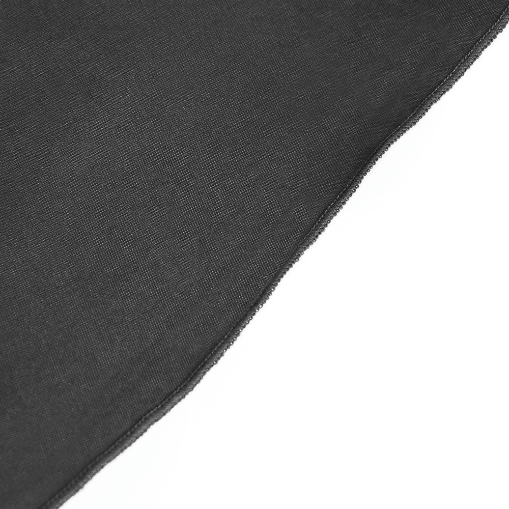 Close-up of a black velvet fabric edge, highlighting texture for a gothic-inspired fashion piece.