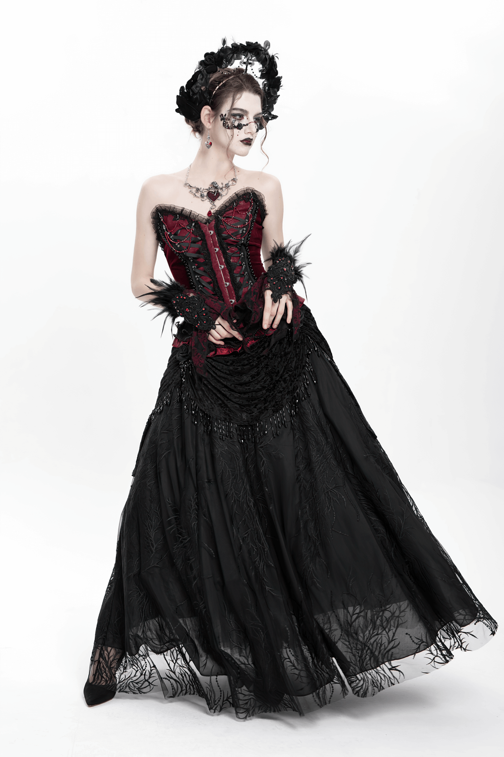 Elegant model in a Gothic black skirt with floral embroidery and beaded accents, exuding dark romance.