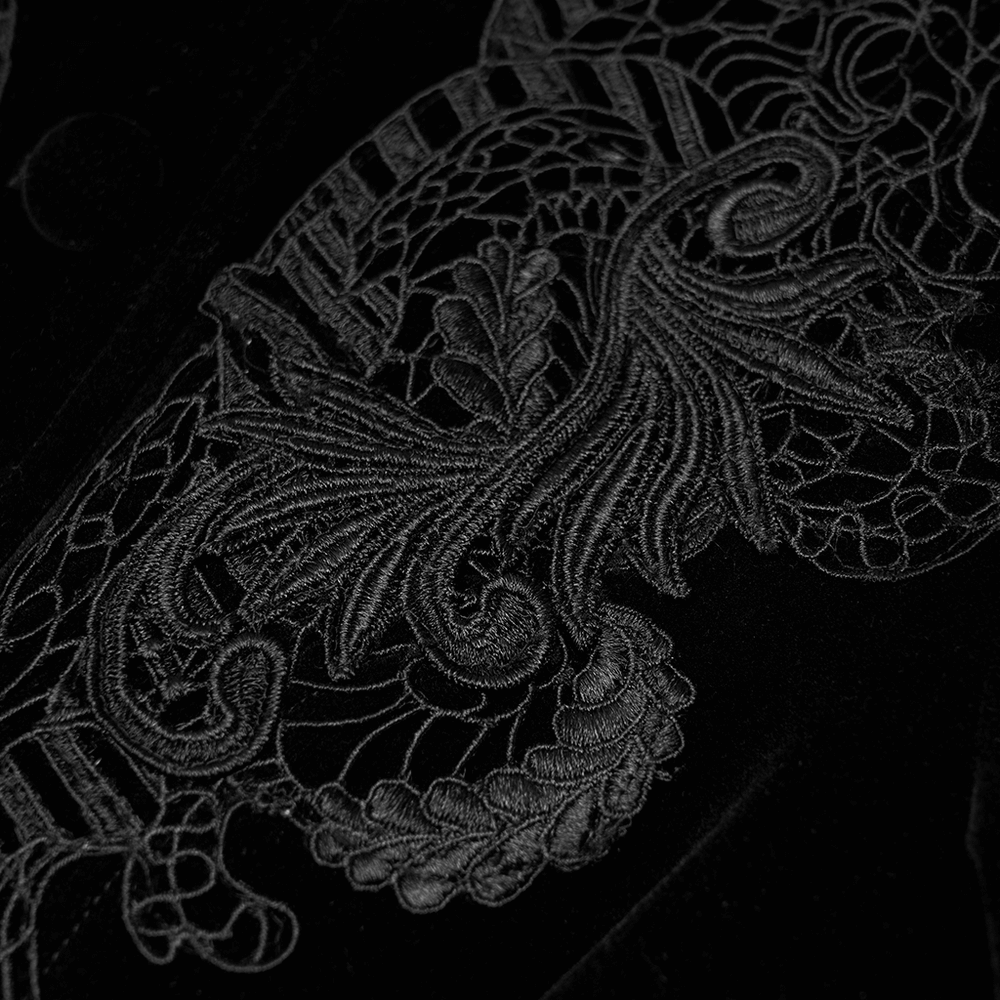 Close-up of intricate black velvet lace pattern, showcasing elegant Gothic embroidery detail.