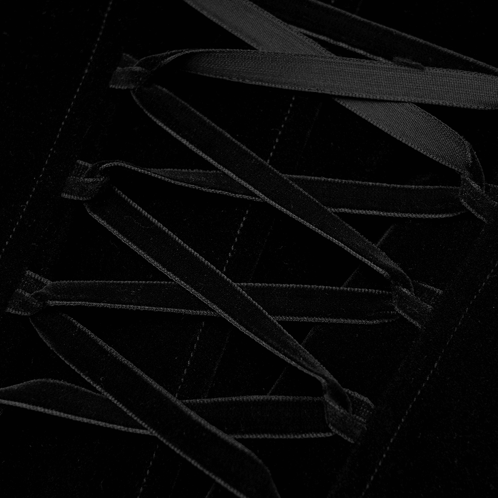 Close-up of dramatic lace-up back detail on elegant Gothic black velvet trench coat.