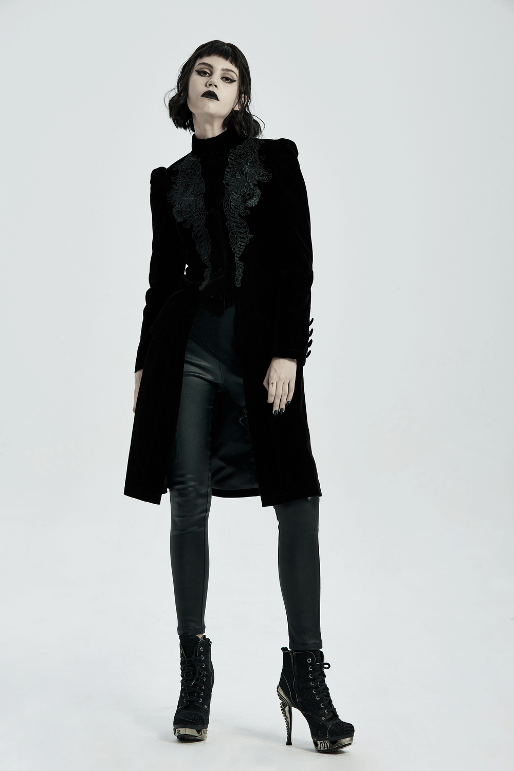 Model showcasing an elegant Gothic black velvet lace-up trench coat with intricate lace detail, perfect for a dramatic evening look.