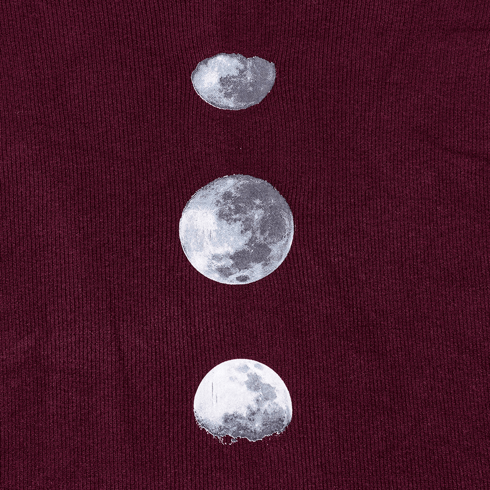 Close-up of elegant burgundy shawl featuring moon phase print in a gothic style.