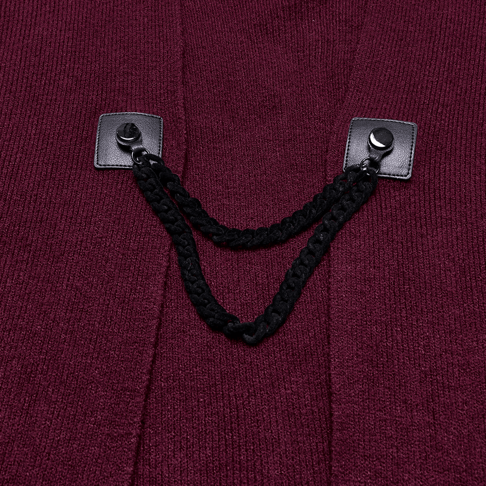 Close-up of elegant burgundy shawl featuring stylish black fasteners and braided rope detail.