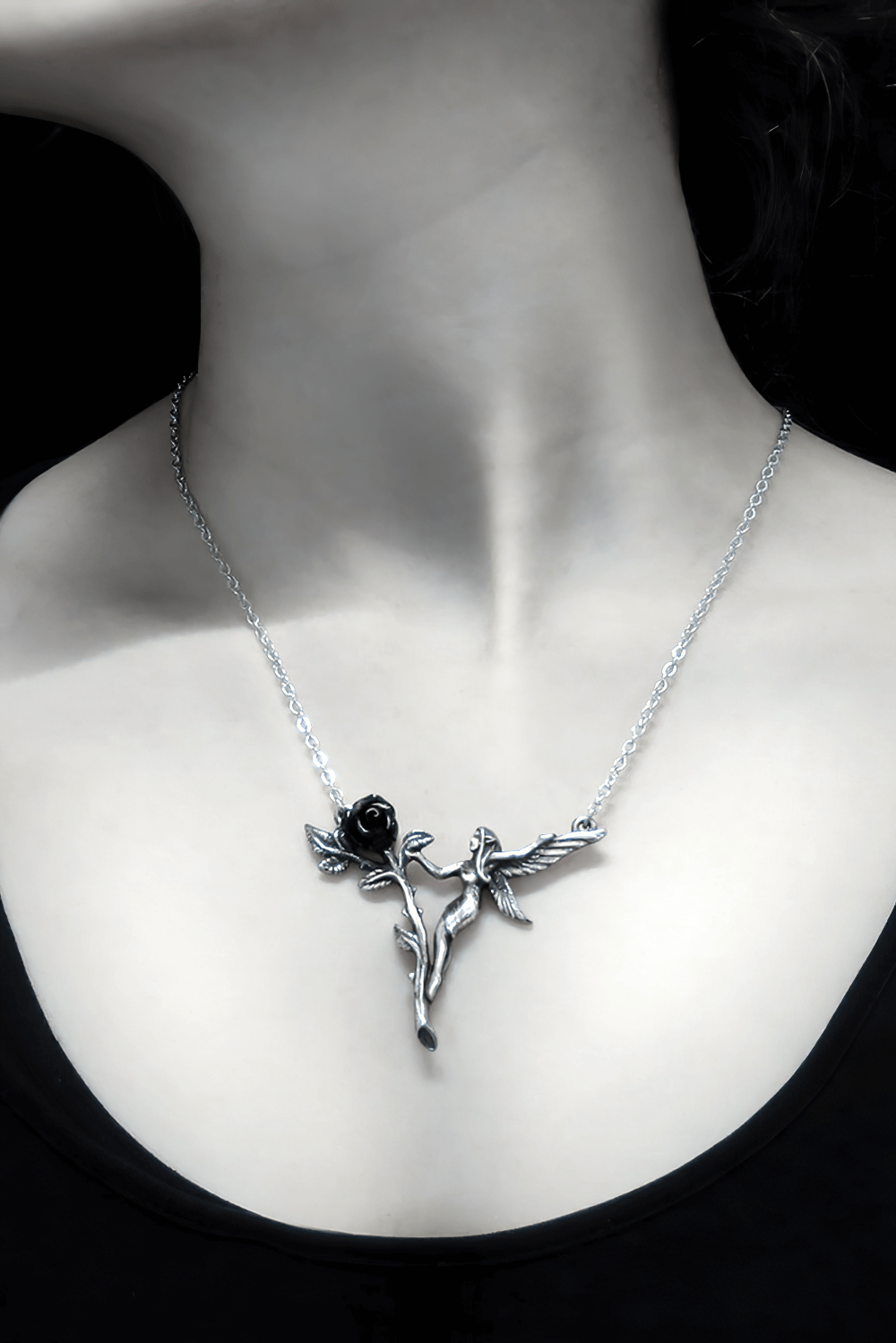 Elegant Gothic fairy necklace with black rose and wings on a model's neck, exuding dark romance.