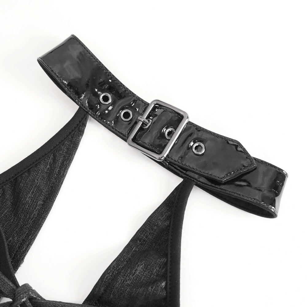 Close-up of black glossy buckle detail on halter dress showing chic lace-up design.