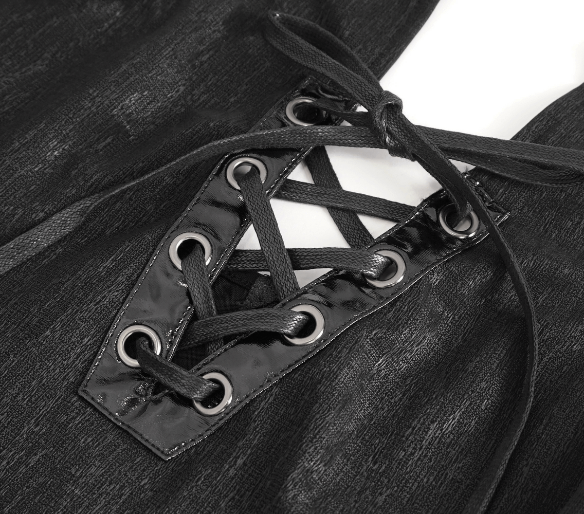 Close-up of chic lace-up detailing on a black elegant Gothic dress with glossy eyelets and ribbon.
