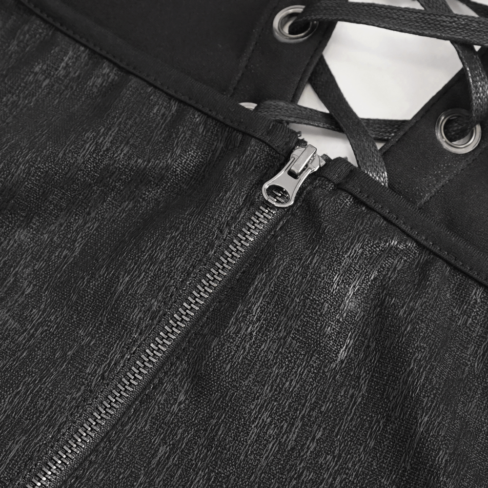 Close-up of lace-up detailing and zipper on an elegant black maxi dress, showcasing chic design features.