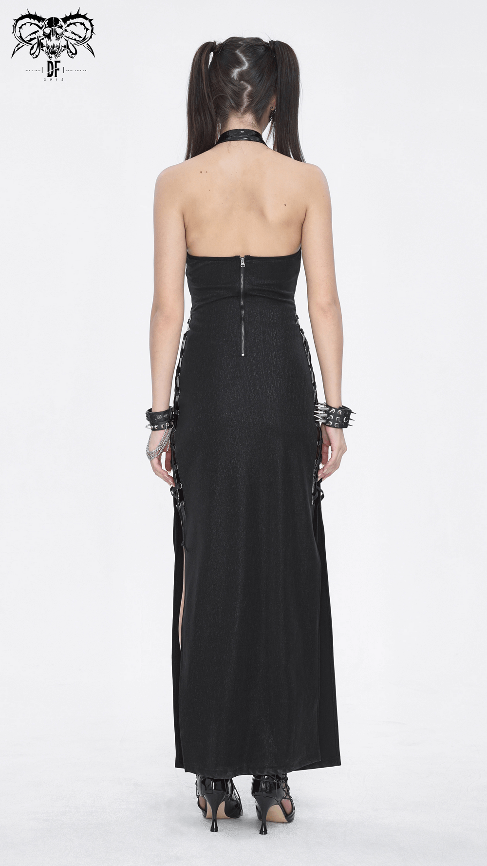Back view of an elegant black Gothic halter maxi dress with lace-up sides and buckle detail, showcasing a daring side slit.