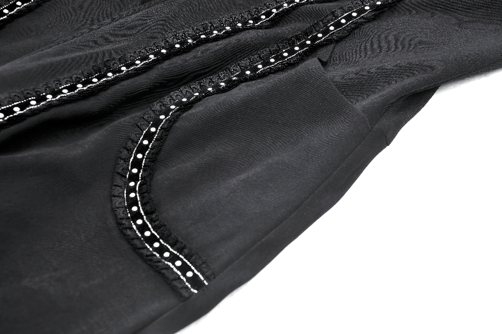 Close-up of black fabric featuring intricate lace detailing and elegant stripe patterns.