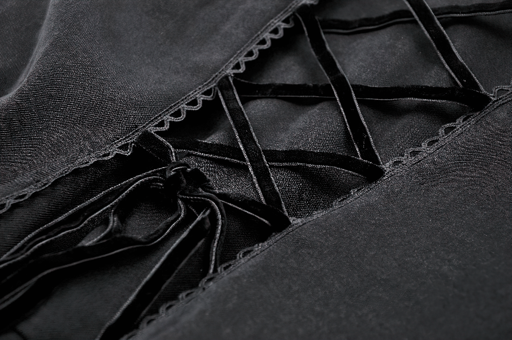Close-up of intricate lace detailing on an elegant black gothic coat, showcasing stylish craftsmanship.