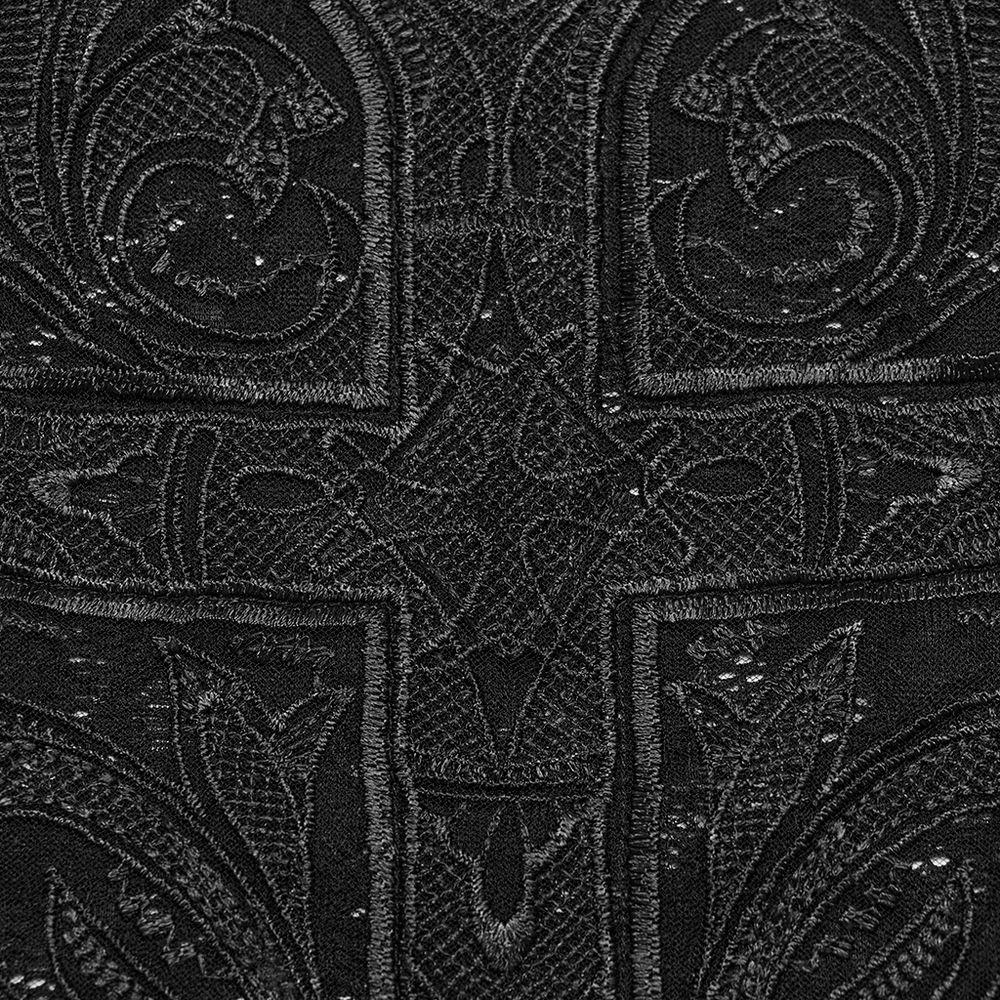 Close-up of intricate black lace fabric featuring gothic cross embroidery and elegant floral patterns.