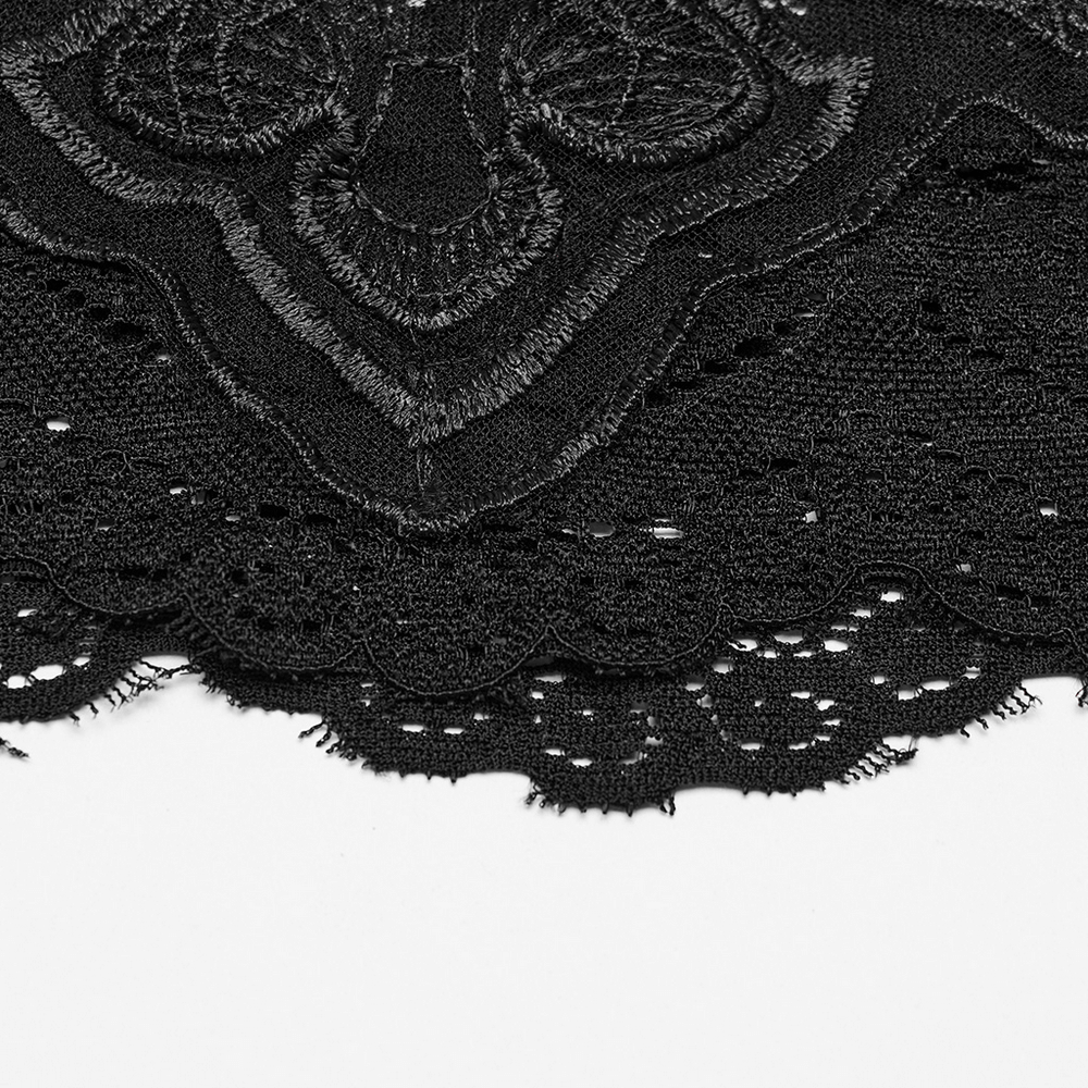 Close-up of elegant black lace fabric showcasing intricate patterns and scalloped edges for gothic style.