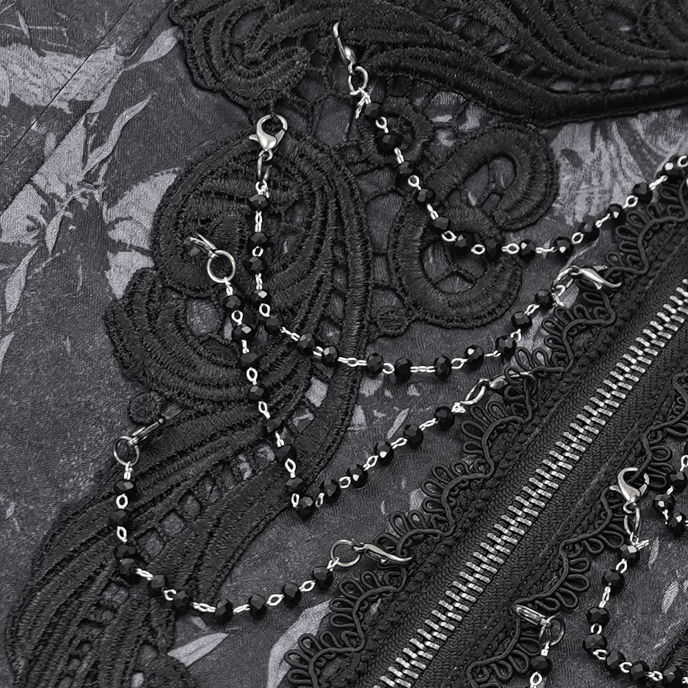 Close-up of intricate black lace and chains on a gothic corset, showcasing Victorian punk style and detailing.