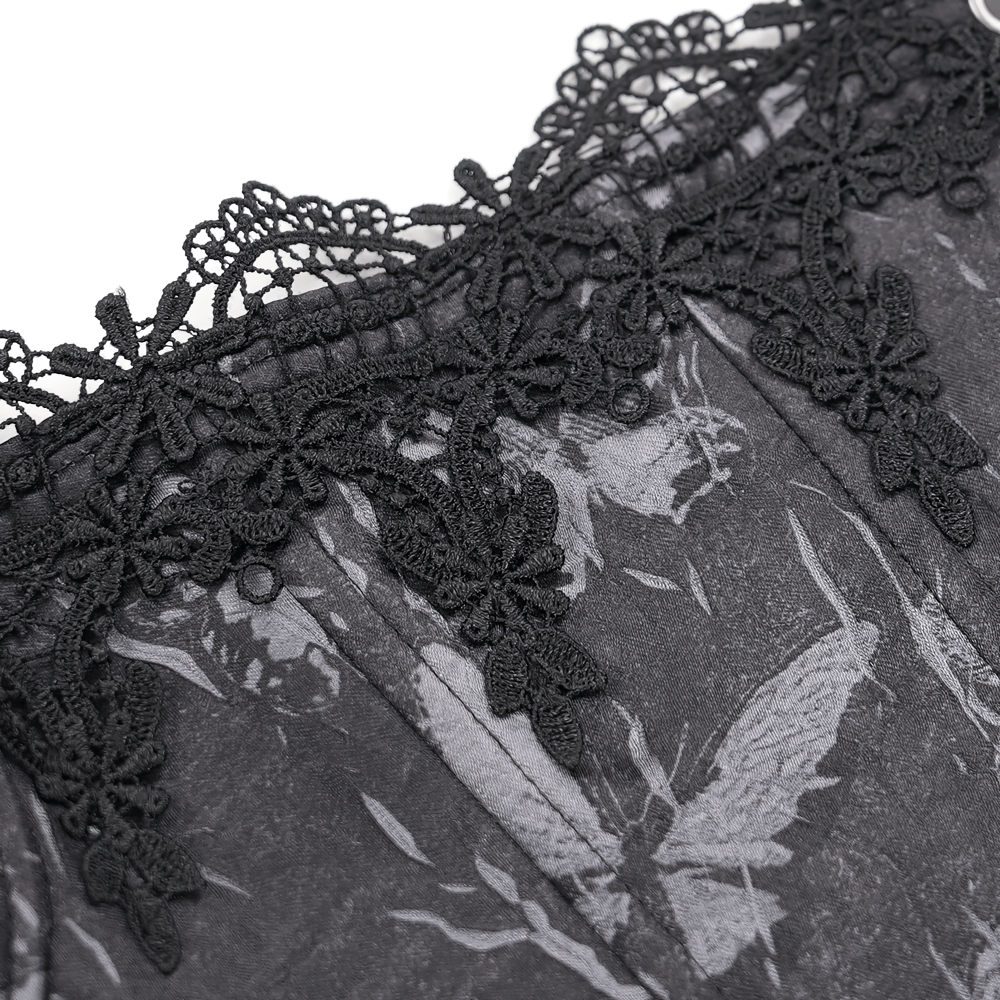 Close-up of elegant black lace trim on gothic corset with floral patterns, showcasing intricate detailing.