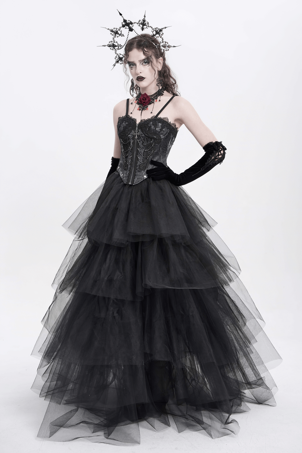 Elegant black goth dress with layered tulle skirt, lace corset, and dramatic accessories.