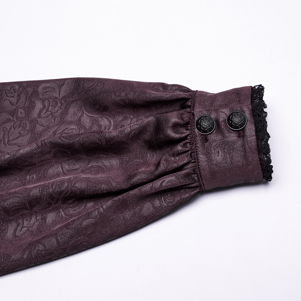 Close-up of the sleeve of an elegant gothic shirt featuring rose-patterned fabric and delicate lace detailing.