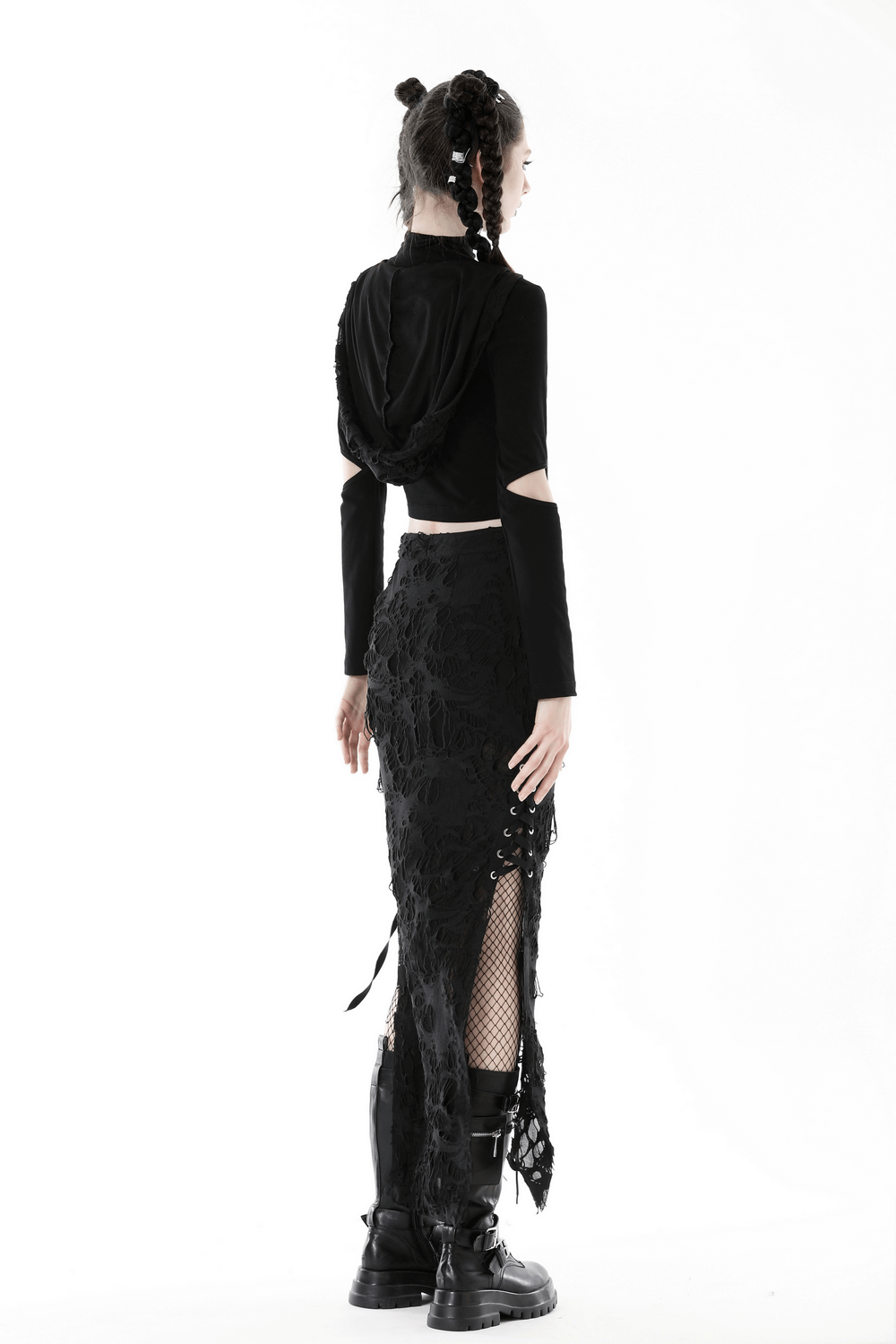 Stylish model showcasing a black gothic long skirt with lace details and side lacing, paired with combat boots.