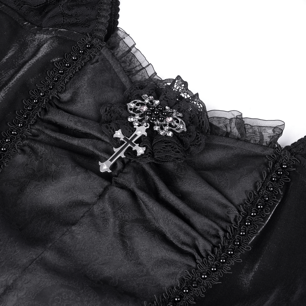 Elegant black gothic dress detail featuring intricate lace, a cross brooch, and textured fabric. Perfect for dark occasions.