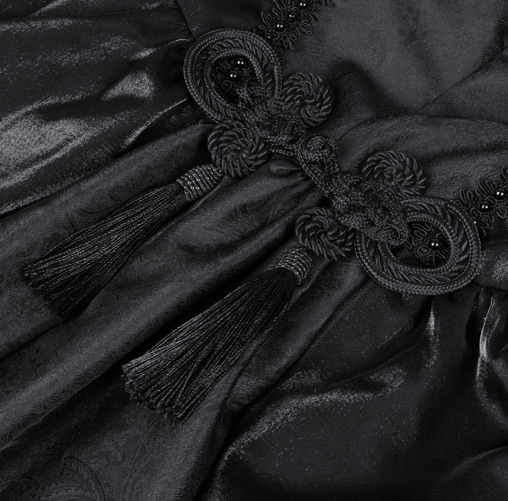 Elegant black dress detail featuring tassels and intricate lace embellishments for gothic flair.