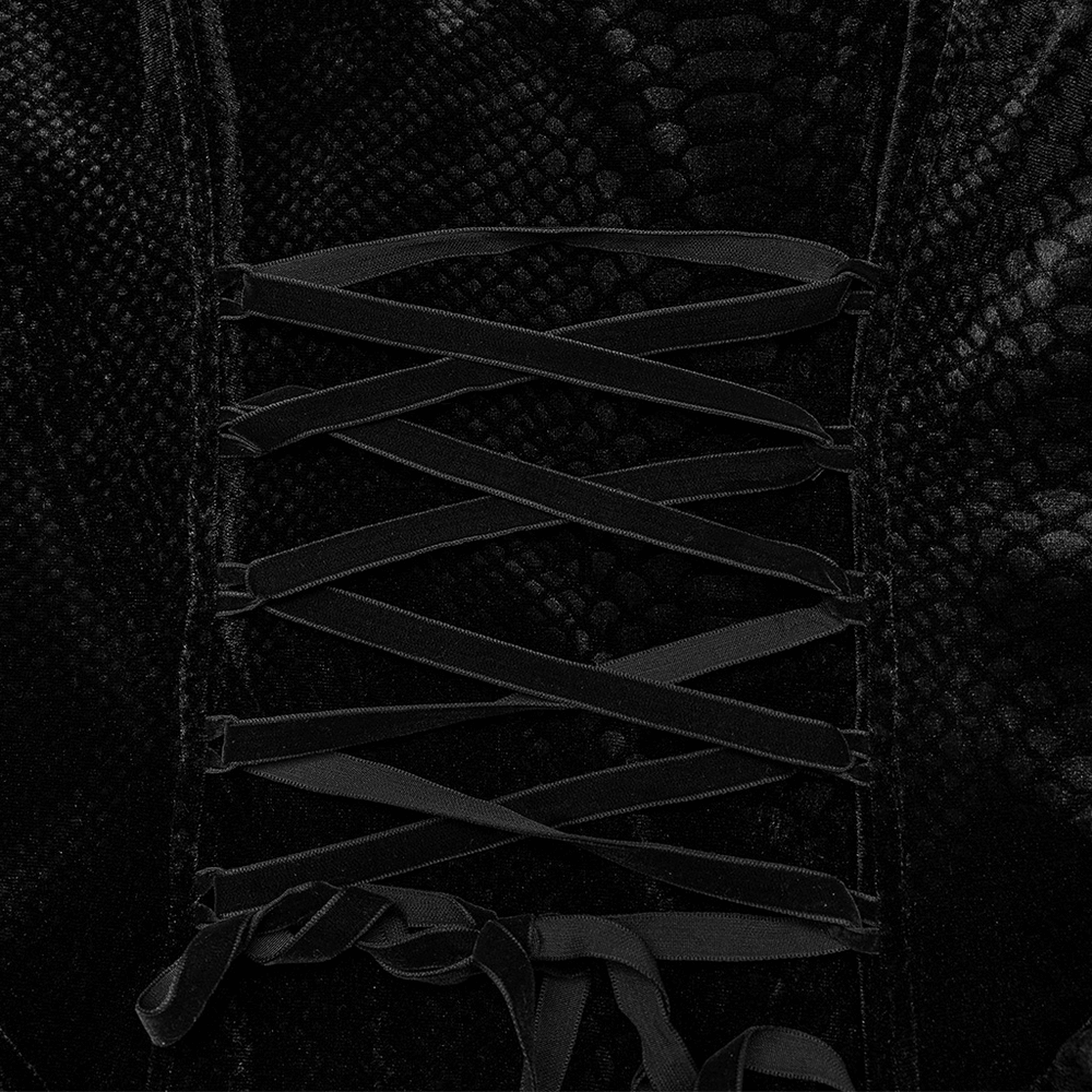 Close-up of gothic lace maxi dress detailing with intricate lace-up design in black velvet.