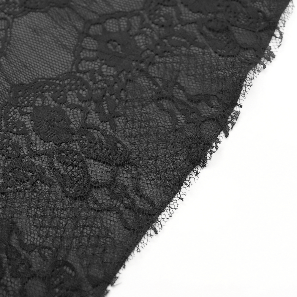 Close-up of black lace with intricate floral embroidery for a gothic skirt.