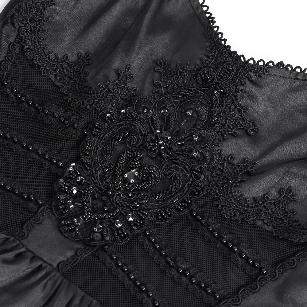 Intricate black lace detailing and embellishments on a gothic maxi dress, showcasing Victorian elegance.