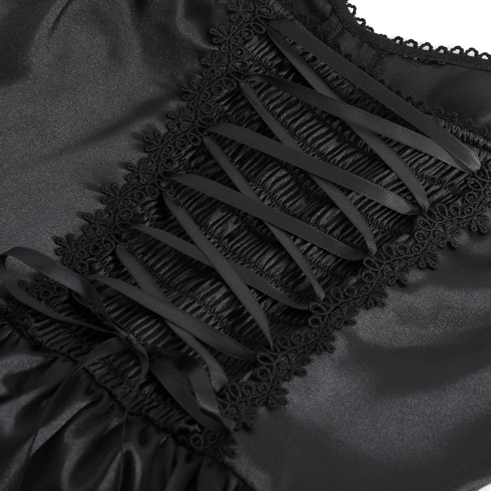 Close-up of intricate lace-up detailing with black ribbons on elegant gothic maxi dress.