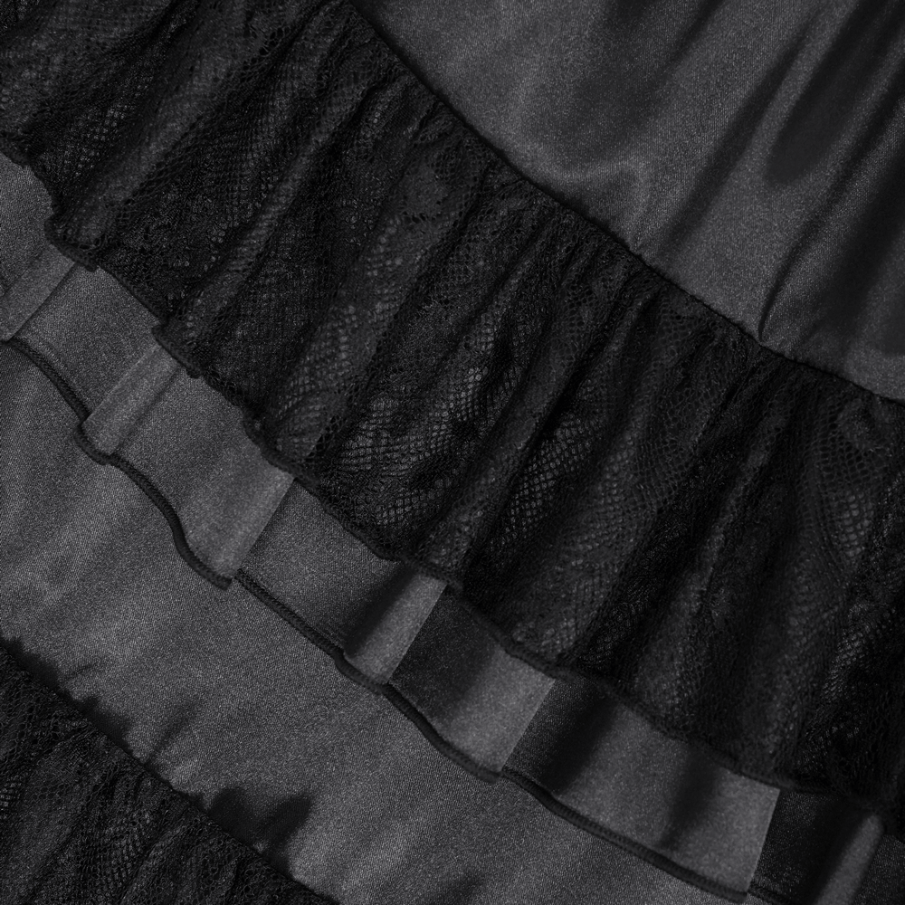 Close-up of elegant black lace and ruffle detailing on a gothic tiered maxi dress, showcasing intricate textures.