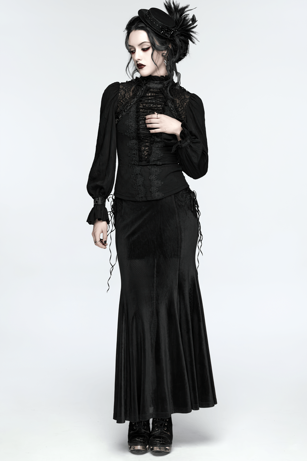 Alt Tag: Elegant Gothic Lace-Up Vampire Blouse With Flared Cuffs on model, black Victorian-inspired lace-up top with dramatic flared cuffs
