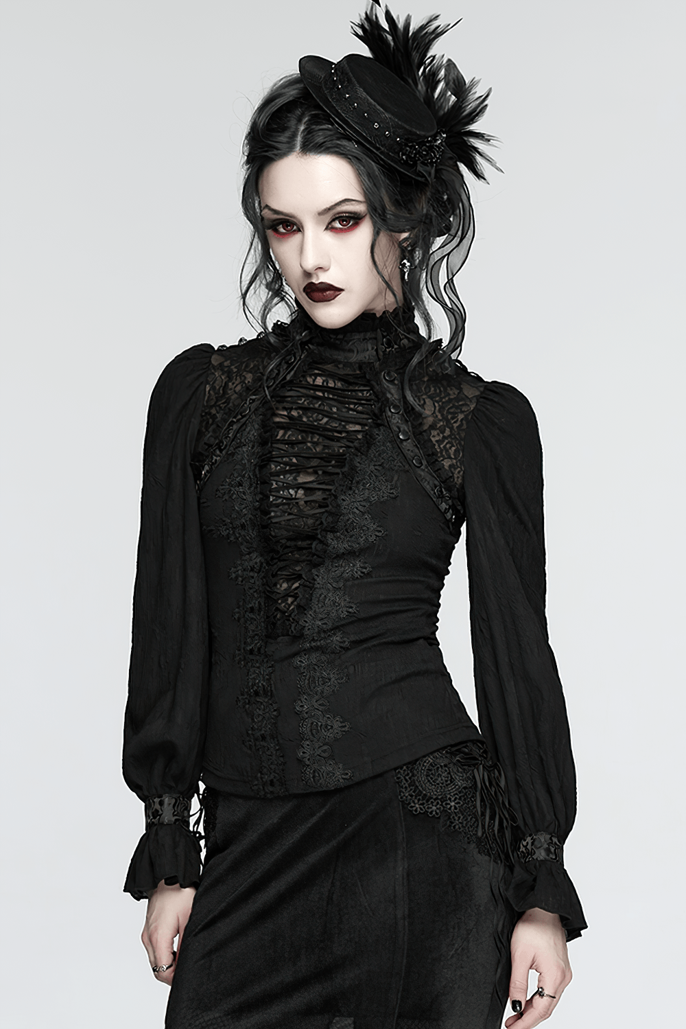 Alt Tag: Elegant Gothic Lace-Up Vampire Blouse With Flared Cuffs on model, black lace-up front, Victorian goth top with dramatic flared cuffs