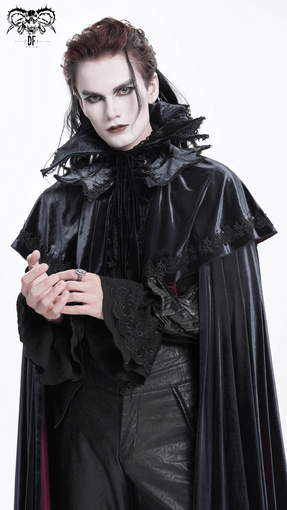 Elegant vampire in a gothic velvet lace collar and cape, embodying dark aesthetic and dramatic flair.