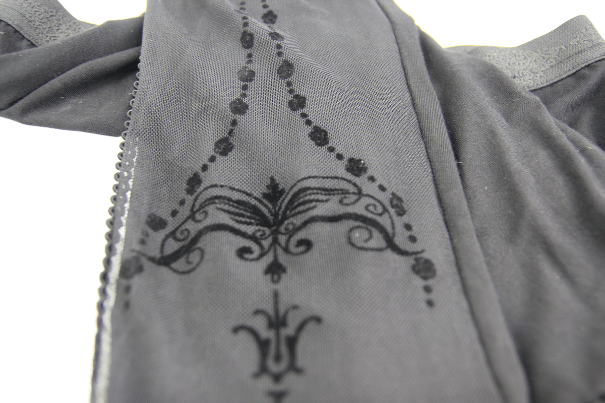 Close-up of elegant black leggings featuring intricate baroque pattern and transparent inserts, perfect for gothic style.